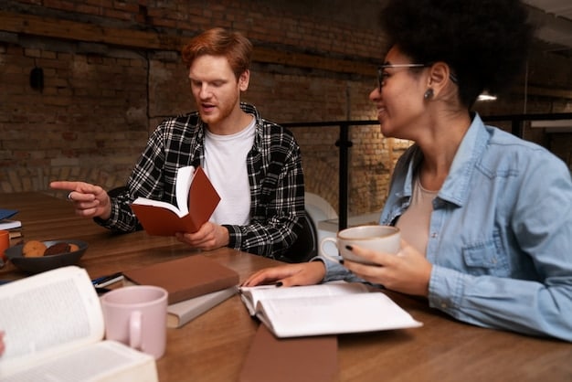 Two students sit at a table, engrossed in a discussion. One student is actively explaining something with a marker on a whiteboard, while the other listens attentively. The environment is a modern study room with natural light, fostering an atmosphere of collaboration and learning.