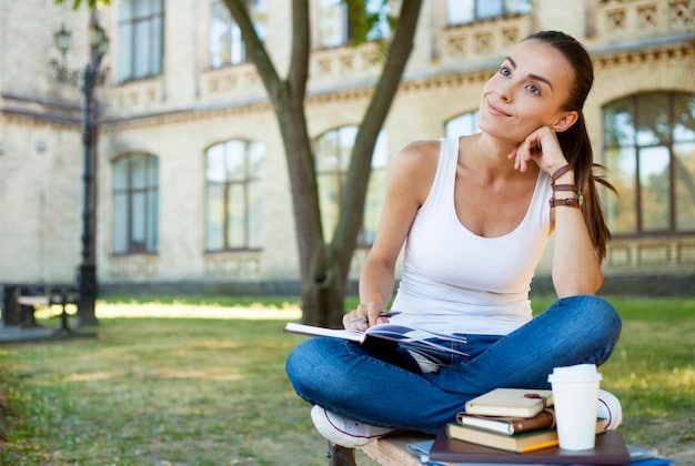 A young woman smiling confidently while participating in a workshop on a college campus. The setting is a sunny outdoor area, suggesting personal development and self-improvement activities.