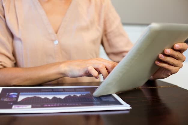A close-up shot of a business owner analyzing a financial spreadsheet on a tablet, with graphs and charts displaying revenue and expense data.