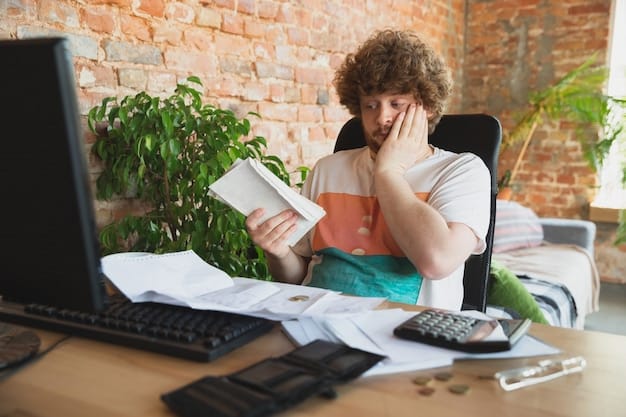 A stressed person sitting at a desk with unpaid bills scattered around and a calculator in hand, highlighting the financial anxiety caused by unexpected expenses and the importance of an emergency fund.