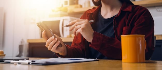 A person making notes while on a phone call, symbolizing the planning and strategy involved in negotiating credit card interest rates.