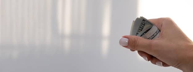 A close-up image of a hand holding cash, with a blurred background showing a person working in a fast-food restaurant. The image should evoke a sense of financial security and the potential impact of the wage increase.
