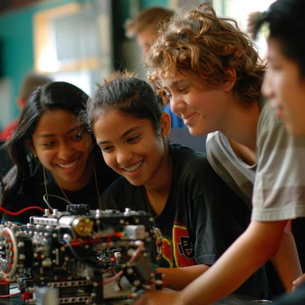 A diverse group of middle school students working together on a robotics project. They are gathered around a table, programming a small robot with laptops and various electronic components. The atmosphere is collaborative and focused, showing the practical application of STEM concepts.