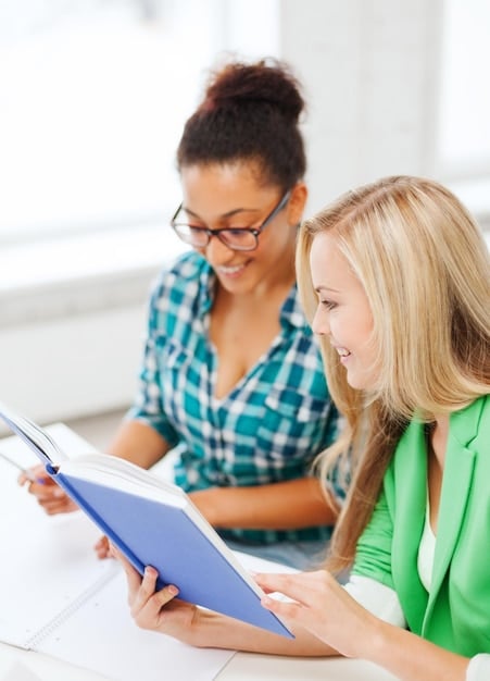 A high school counselor advising a student about scholarship opportunities, with brochures and application forms spread across the table. The image emphasizes the importance of seeking guidance from educational professionals.