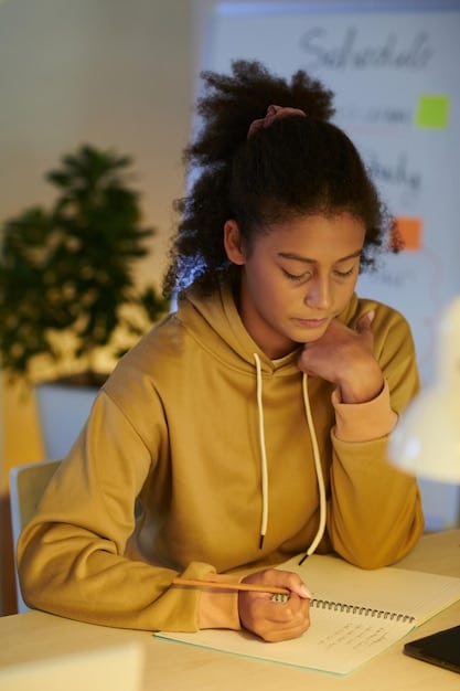 A close-up shot of a student thoughtfully writing an essay for their college application, with soft, natural light highlighting their focused expression.