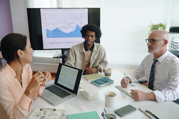 A diverse group of people collaborating around a table, brainstorming financial goals and investment strategies, with laptops and charts displayed.