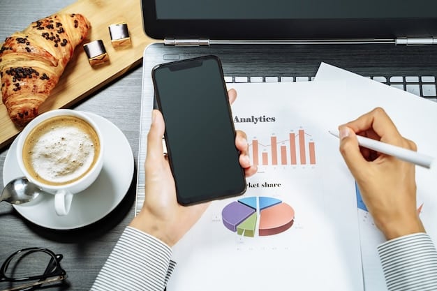 A person holding a phone displaying a budgeting app with colorful charts and graphs illustrating income and expenses, set in a modern, minimalist office environment.