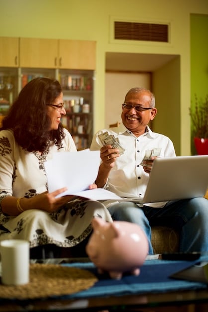 A family sitting around a table, looking at financial documents and having a calm, open discussion about money. The atmosphere is supportive and educational.